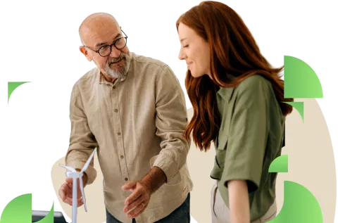 Two people gathered around a desk reviewing papers and having a collaborative discussion